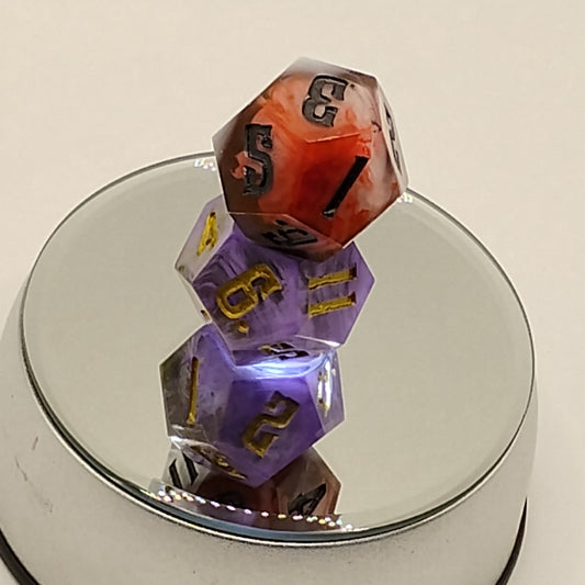 Colorful dice with numbers on a reflective surface