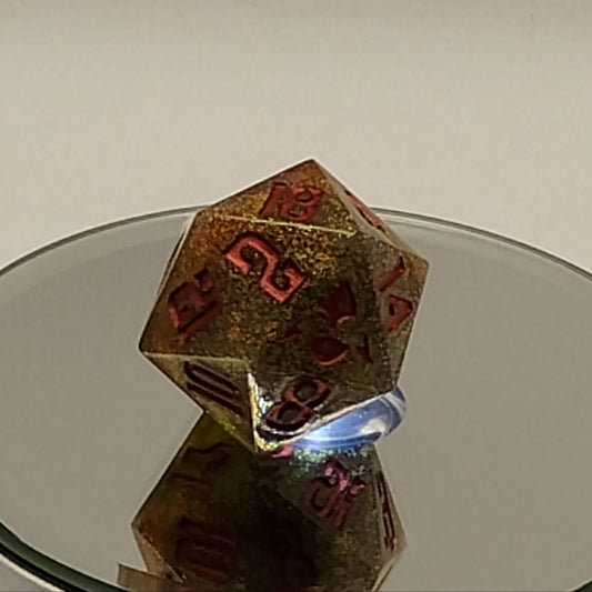 Close-up of a metal D20 polyhedral dice with numbers on a plain background