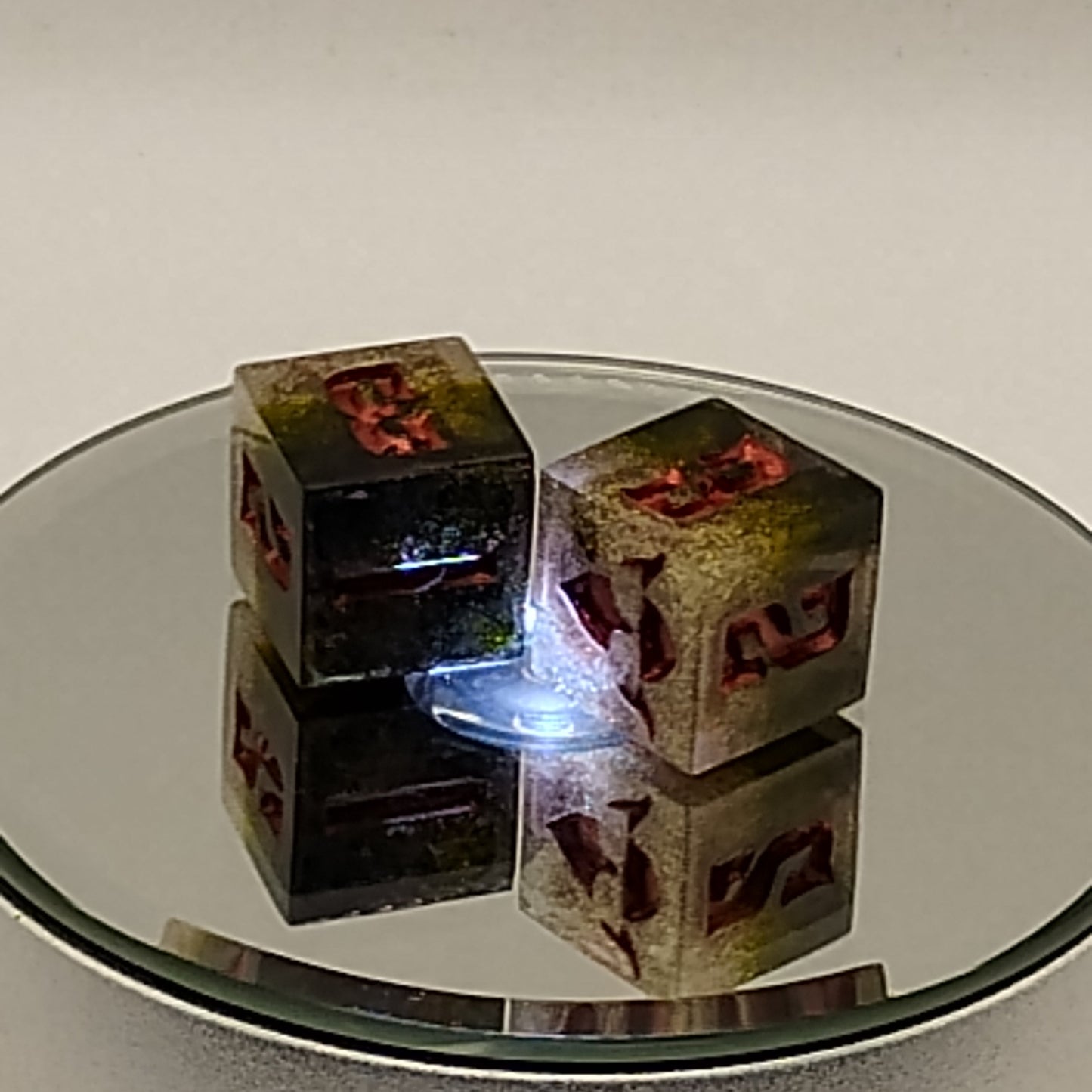 Reflection of a decorative mirror with a floral design on a plain wall.