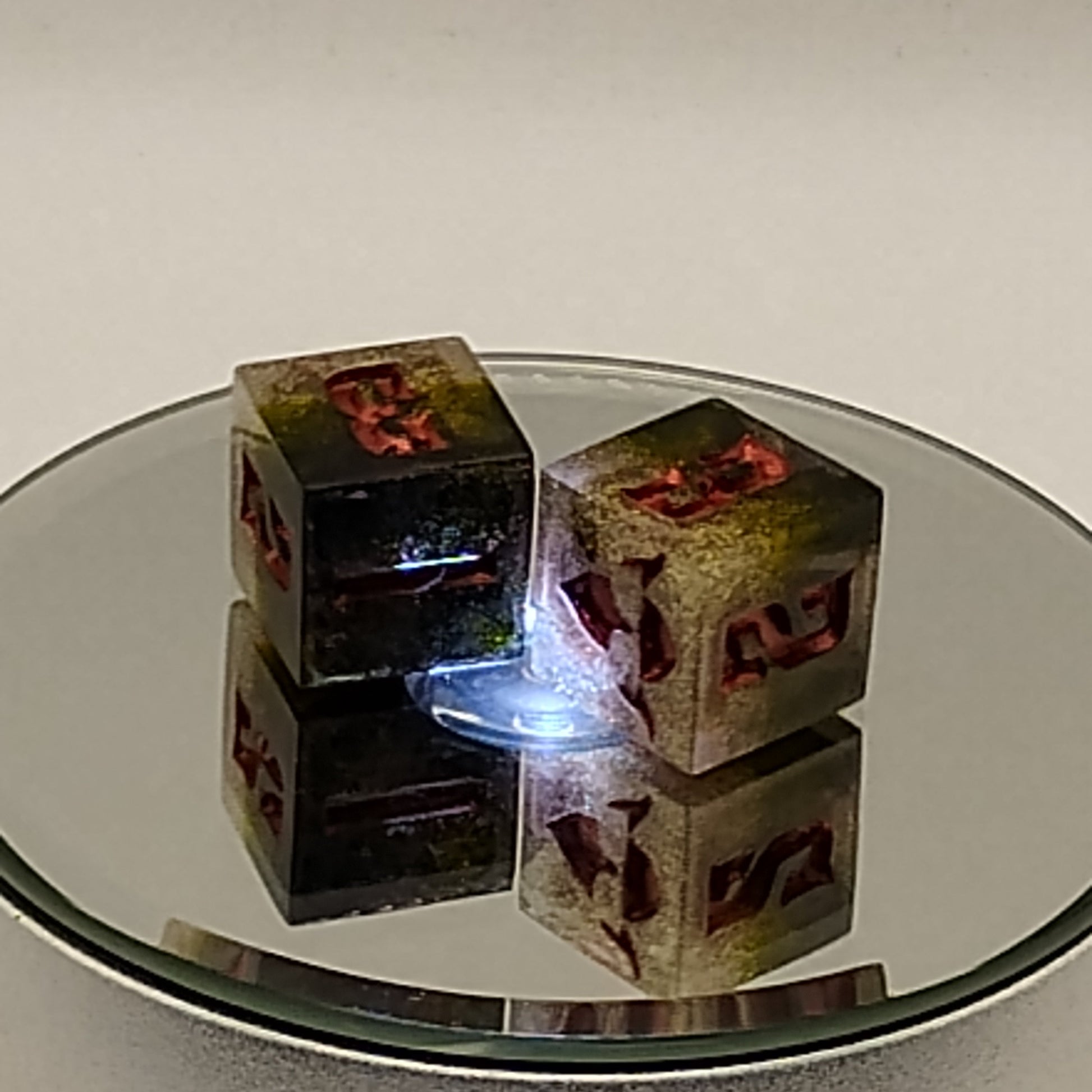 Reflection of a decorative mirror with a floral design on a plain wall.