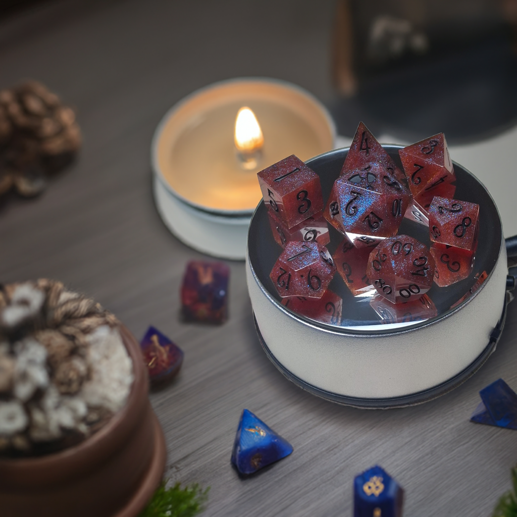Red resin dice set with black numbers in metal container, candle, and decorative plant.