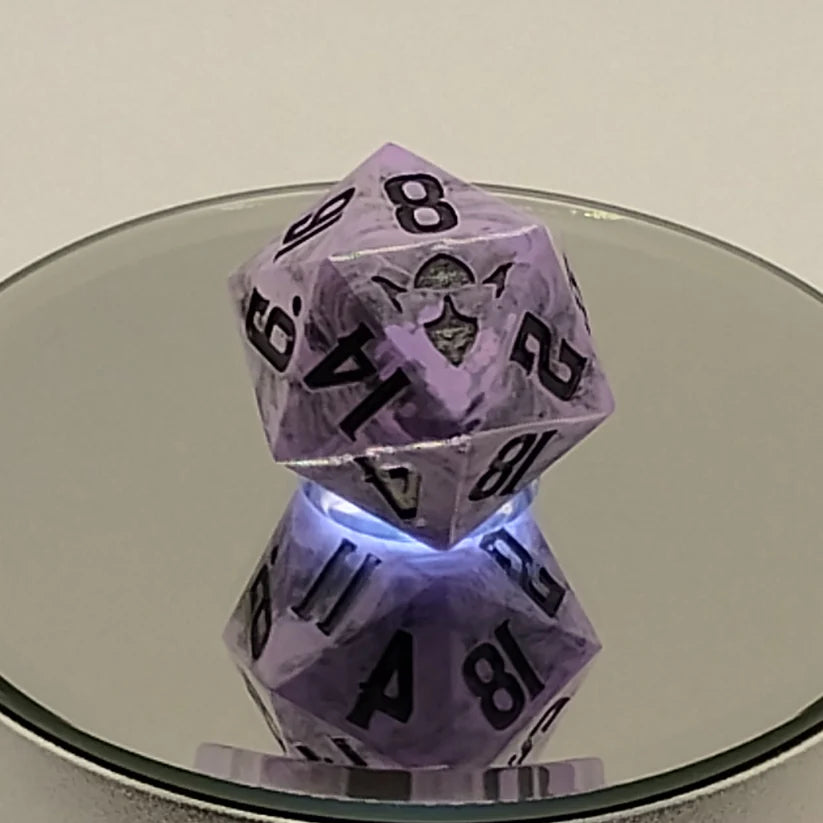 Two purple polyhedral dice on a reflective surface