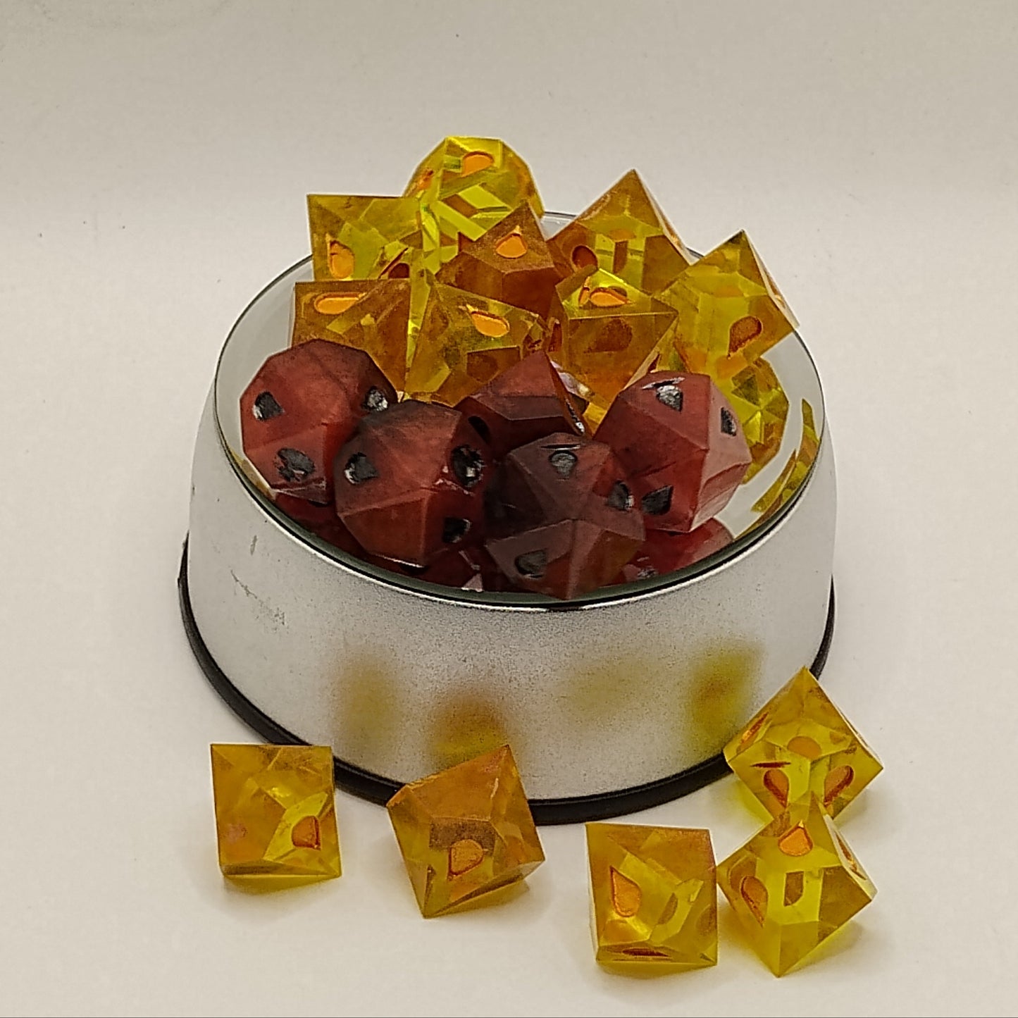 Clear plastic cubes with red and black shapes on a white surface