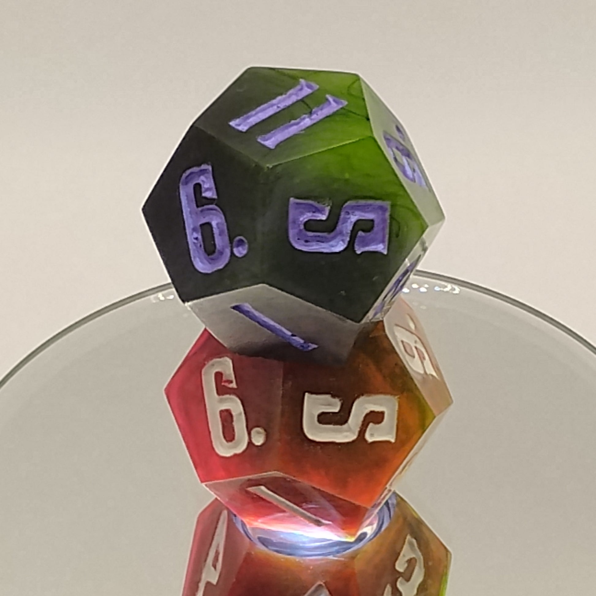 Colorful polyhedral dice set on a reflective surface