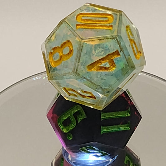 Three polyhedral dice with different colored numbers on a reflective surface