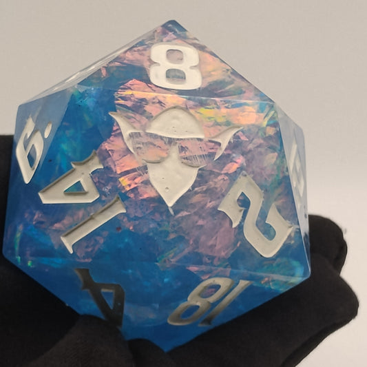 Holographic blue polyhedral dice held by a gloved hand against a neutral background